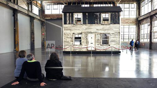 FILE - In this April 1, 2018 file photo, visitors view the rebuilt house of Rosa Parks at the WaterFire Arts Center in Providence, R.I. The house where Parks sought refuge in Detroit after fleeing the South will be auctioned on Thursday, July 26 in New York, with a minimum bid of $1 million. (AP Photo/Steven Senne, File)