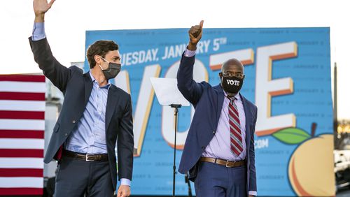 From left, Democratic Senate candidates Jon Ossoff and the Rev. Raphael Warnock wave after a campaign event with President-elect Joe Biden in Atlanta on Monday, Jan. 4, 2021. Their wins in runoff elections Tuesday gave Democrats control of the Senate. (Doug Mills/The New York Times)