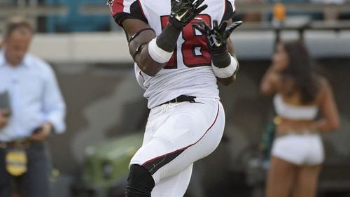 Atlanta Falcons wide receiver Freddie Martino (18) catches a pass for a 67-yard touchdown against the Jacksonville Jaguars during the first half of an NFL preseason football game in Jacksonville, Fla., Thursday, Aug. 28, 2014. (AP Photo/Phelan M. Ebenhack)
