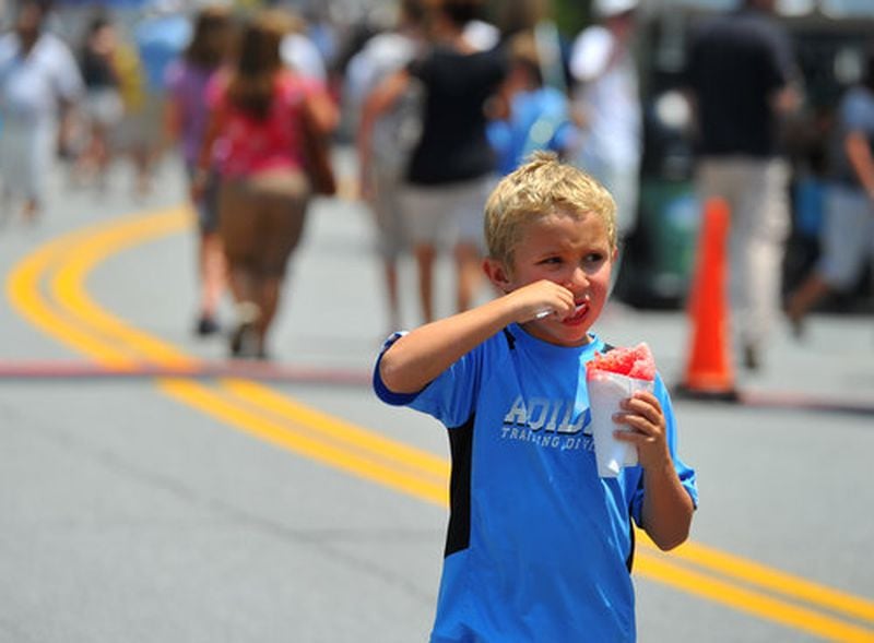 Kenneth Cox seeks relief from the heat via shaved ice at the Peachtree Corners Festival.