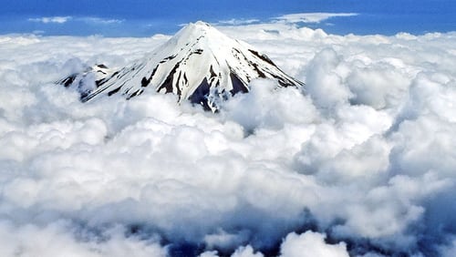 The summit of New Zealand’s Mt. Taranaki, a cone-shaped dormant volcano, is pictured here above the clouds. A Playboy playmate is at the center of a controversy for posing nude on the volcano because it’s considered a sacred place by the Maori tribe.