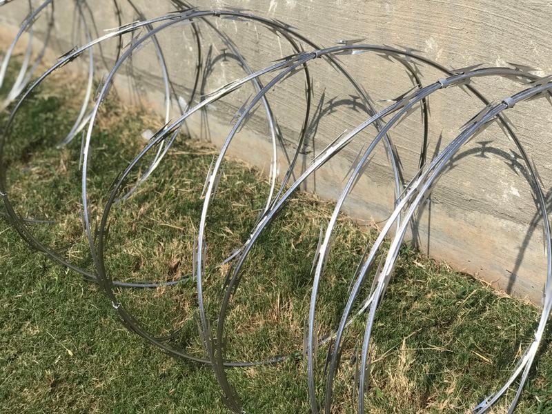 Hartsfield-Jackson officials display a coil of the concertina wire at a press conference.