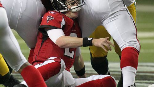 Atlanta Falcons quarterback Matt Ryan eats his face mask as he fumbles the ball on a sack.
