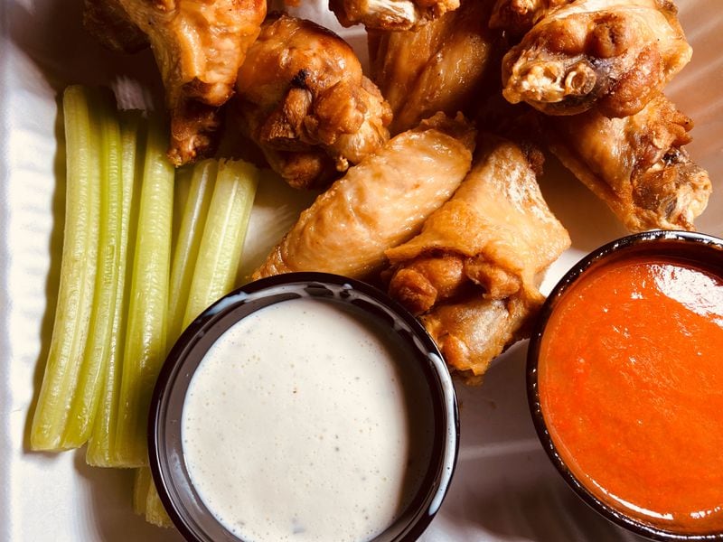 The Buffalo wings at Stats are served with celery, ranch dressing and hot sauce. Bob Townsend for The AJC