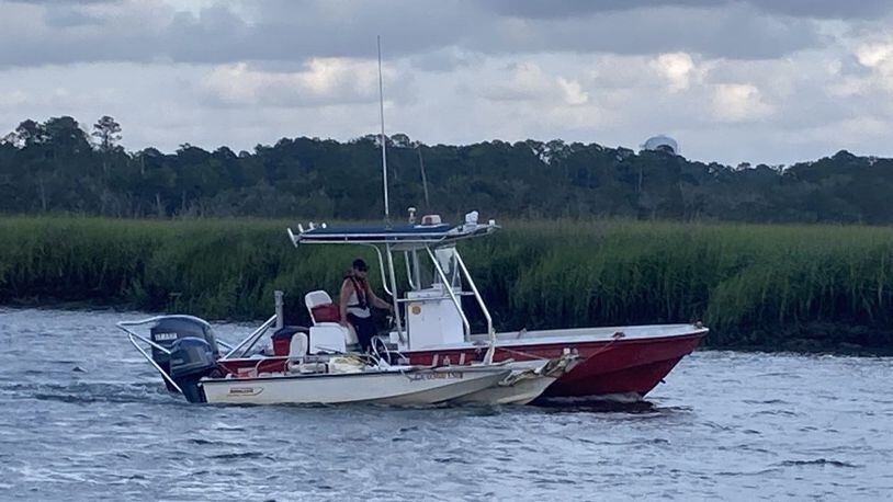 A boat involved in a single-craft accident in Turners Creek is towed past the public boat ramp. (Photo Courtesy of Adam Van Brimmer/Savannah Morning News)