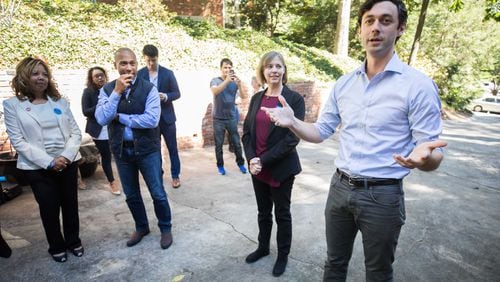 Democratic candidate for 6th District Lucy McBath (L-R), former Governor of Massachusetts Deval Patrick, and Sally Harrell, who is running for a Dunwoody-based state Senate district, listens as Jon Ossoff speaks to campaign volunteers and supporters, Saturday, Oct. 13, 2018, in Atlanta