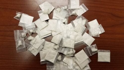 More than 60 baggies of crack and powder cocaine were recovered by authorities after a man allegedly threw them out of a window during a traffic stop in Douglas County.
