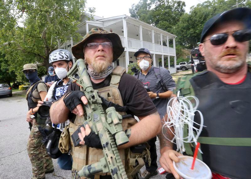 III% Security Force leader Chris Hill (center) brought a handful of his militia members to face off against counter protesters at a rally Saturday, Aug. 15, 2020, in Stone Mountain, Georgia. Militia groups have suffered from social media bans in the past year, experts say. (Jenni Girtman/Atlanta Journal-Constitution/TNS)
