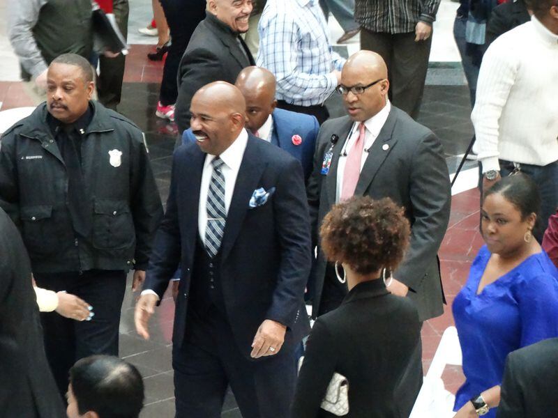 Steve Harvey was about to leave the press conference when he heard a bunch of fans near the entrance of Atlanta City Hall who called out. He ran down and met them despite protestations from some of his entourage, trying to keep him on time. CREDIT: Rodney Ho/rho@ajc.com