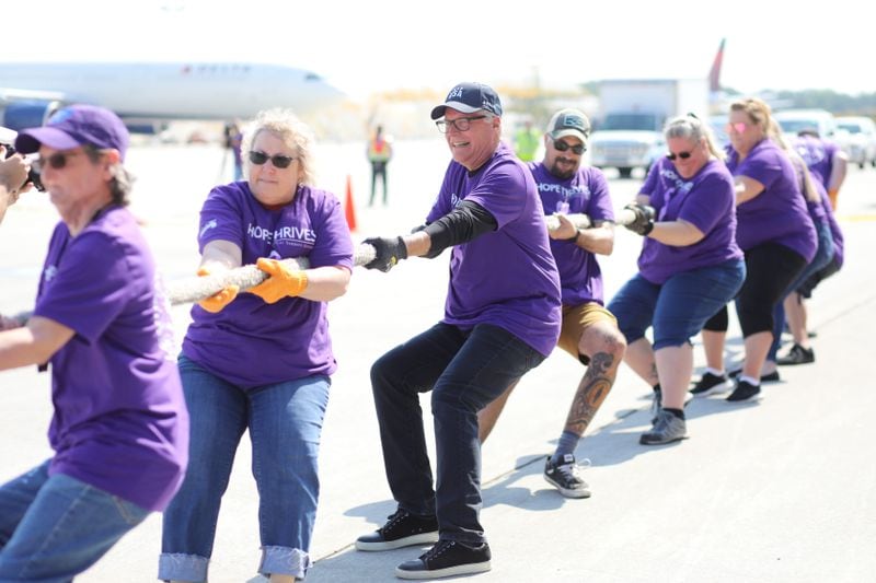 Delta CEO Ed Bastian (center) took part in the Jet Drag event with the "Hope Thrive" team. The team featured Delta employees who either have cancer, are cancer survivors, or are caretakers during the Jet Drag fundraising event on Wednesday, May 4, 2022. Miguel Martinez /miguel.martinezjimenez@ajc.com