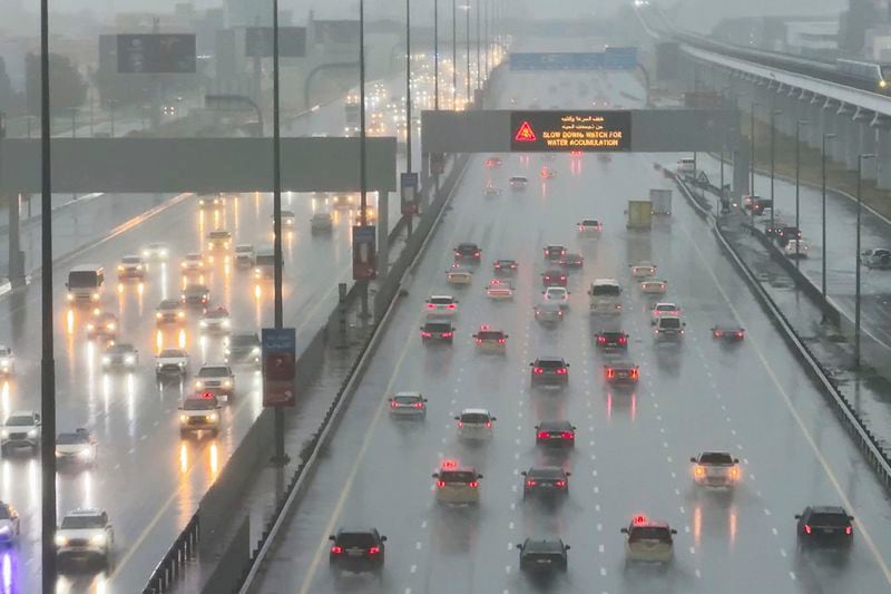 Vehicles drive through heavy rain on the Sheikh Zayed Road highway in Dubai, United Arab Emirates, Tuesday, April 16, 2024. Heavy rains lashed the United Arab Emirates on Tuesday, flooding out portions of major highways and leaving vehicles abandoned on roadways across Dubai. Meanwhile, the death toll in separate heavy flooding in neighboring Oman rose to 18 with others still missing as the sultanate prepared for the storm. (AP Photo/Jon Gambrell)