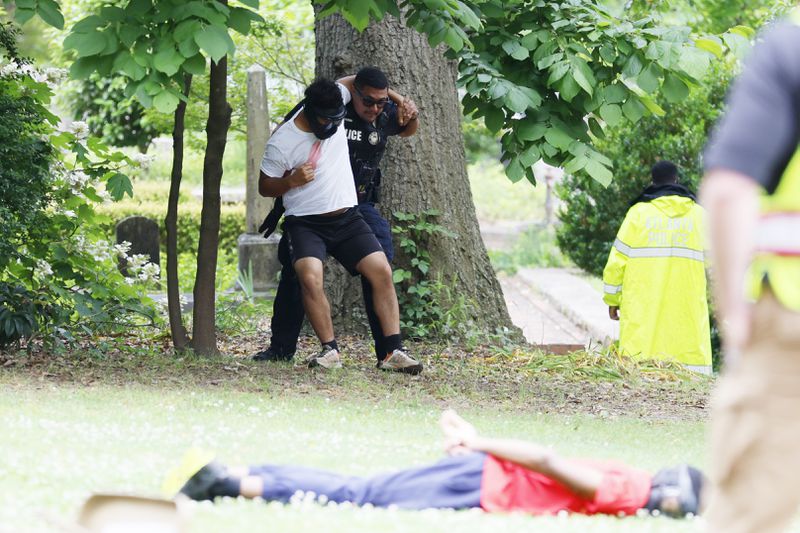 (POLICE TRAINING) A member of the Atlanta Police Department is evacuating an individual playing the victim role as part of an active shooting drill at the Oakland Cemetery on Thursday, May 18, 2023.
Miguel Martinez /miguel.martinezjimenez@ajc.com