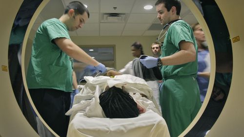 John Dugan, RT (left) and Dr. John Dooley prepare  a motor vehicle crash victim for a CT scan at Atlanta Medical Center on  March 10, 2011.   Bob Andres bandres@ajc.com