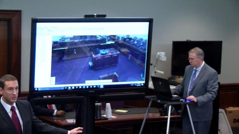 David Dustin, right, demonstrates to the jury how 3D laser scanning can create a 3D scan of the courtroom, during the murder trial of Justin Ross Harris at the Glynn County Courthouse in Brunswick, Ga., on Friday, Oct. 28, 2016. (screen capture via WSB-TV)