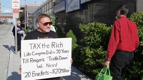 FILE - In this April 17, 2012, photo, James Hodgkinson of Belleville protests outside of the United States Post Office in Downtown Belleville, Ill. A government official says the suspect in the Virginia shooting that injured Rep. Steve Scalise and several others has been identified Hodgkinson. (Derik Holtmann/Belleville News-Democrat, via AP)