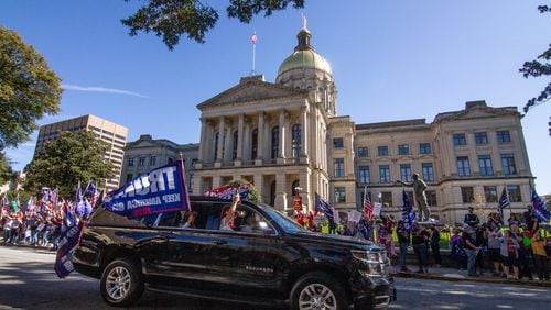 Cars and trucks with signs in support of President Donald Trump circle the state Capitol in Atlanta on Saturday, November 14, 2020. (Photo: Steve Schaefer for The Atlanta Journal-Constitution)