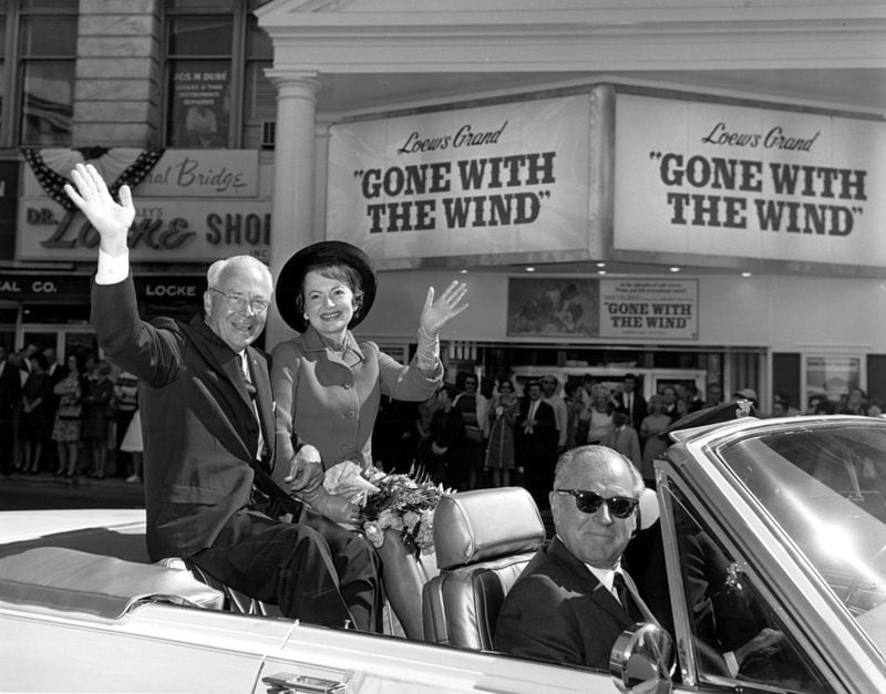 Mayor Ivan Allen Jr. and actress Olivia De Havilland wave to the crowd during a parade celebrating the re-release of the movie 'Gone With the Wind" in 1967. 