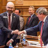 State Sen. Larry Walker III, R-Perry (right), fist bumps Sen. Josh McLaurin, D-Sandy Springs, during a lighter moment of the 2024 legislative session, on March 4, 2024. Walker co-sponsored Senate Bill 390, which sought to banish the influence of the American Library Association. It remained bottled up in the House Higher Education Committee on March 28, the final day of the legislative session. (Arvin Temkar / arvin.temkar@ajc.com)