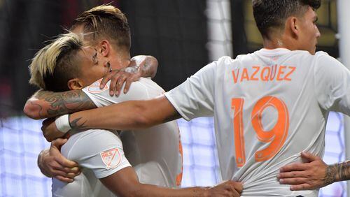 July 21, 2018  - Atlanta United forward Josef Martinez (7) is congratulated by teammates after his 6th career MLS hat trick during the second half in a MLS soccer game at Mercedes-Benz Stadium on Saturday, July 21, 2018. Three more goals from Josef Martinez set a new MLS record lifted Atlanta United to a 3-1 victory over D.C. United on Saturday at Mercedes-Benz Stadium. HYOSUB SHIN / HSHIN@AJC.COM