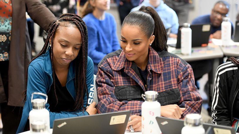 Cedreice Allen, a ninth grade student at Paul Duke STEM High School shows R&B singer-songwriter Ciara how she used digital technology to re-mix her song “SET” the artist’s latest album. (Photo by Paras Griffin/Getty Images for Amazon)