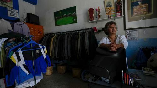 A seller waits for customers despite not having electricity due to a programed power cut by the ministry of energy, in Quito, Ecuador, Tuesday, April 16, 2024. Ecuador faces electricity rationing due to a prolonged drought and high temperatures that have reduced flows to the main hydroelectric plants. (AP Photo/Dolores Ochoa)