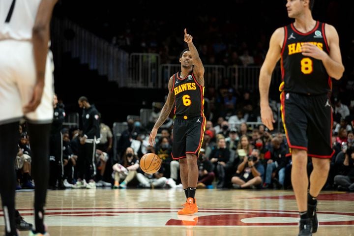 The Hawks' Lou Williams (6) points at the net during a game between the Atlanta Hawks and the Brooklyn Nets at State Farm Arena in Atlanta, GA., on Friday, December 10, 2021. (Photo/ Jenn Finch)