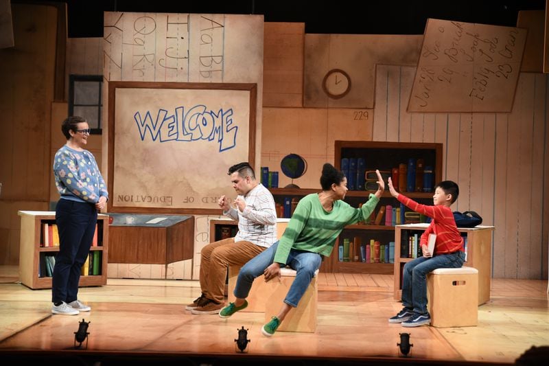 Third grader Henry (played by talented 11-year-old Alexander Chen) gets a high-five from a classmate (India Tyree) for regurgitating the facts he just absorbed from literally eating his school books.