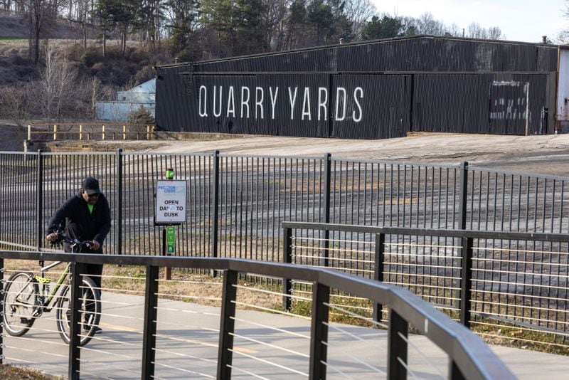 A bicyclists walks past an area that is planned to be used for Microsoft’s Westside Atlanta campus on Tuesday, Feb. 7, 2023. (Arvin Temkar / arvin.temkar@ajc.com)