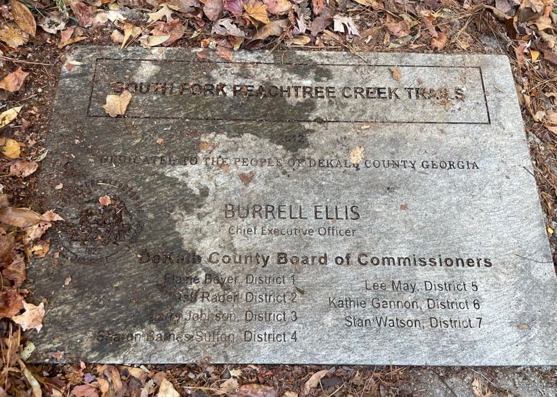 A commemorative stone at a DeKalb County nature path denotes a number of public officials who would later get in trouble.