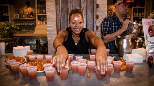Kesha Bellamy sets out Cherokee Purple cocktails at JCT Kitchen and Bar during the 7th annual Attack of the Killer Tomato Festival at JCT Kitchen and Bar in Atlanta, Ga. Sunday July 19th.STEVE SCHAEFER / SPECIAL TO THE AJC