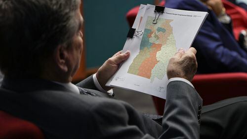 Rep. Richard Smith, R–Columbus, flips through a packet with revised congressional district maps during a reapportionment and redistricting hearing at the Georgia State Capitol on Tuesday, December 5, 2023. (Natrice Miller/natrice.miller@ajc.com)