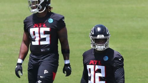 Falcons defensive lineman Ta’Quon Graham (left) and outside linebacker Ade Ogundeji (right) loosen up during rookie minicamp on Friday, May 14, 2021, in Flowery Branch.     “Curtis Compton / Curtis.Compton@ajc.com”