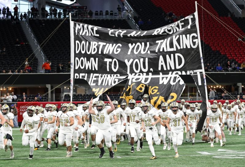 Calhoun players run onto the field before their game against Peach County during the Class AAA Championship at Mercedes-Benz Stadium Friday, December 8, 2017, in Atlanta.