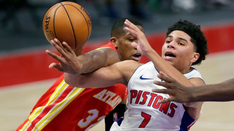Pistons guard Killian Hayes (7) is fouled by Hawks guard Kris Dunn (32) during the fourth quarter Monday, April 26, 2021, in Detroit. (Duane Burleson/AP)