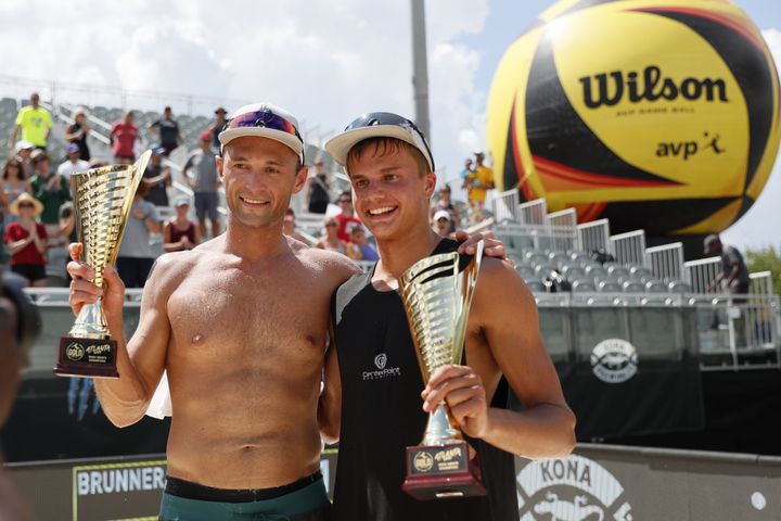 Paul Lotman and Miles Partain hold their trophies after winning the AVP Gold Series Atlanta Open beach volleyball men's championship match Sunday at Atlantic Station. (Miguel Martinez / miguel.martinezjimenez@ajc.com)
