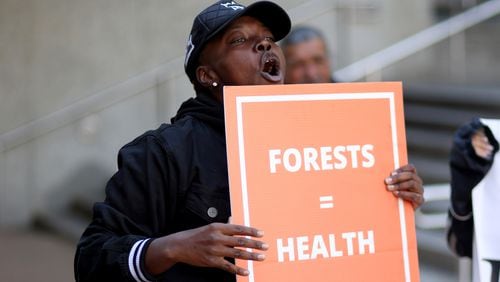 Nekia Fisher, of Atlanta, participates in a rally against industrial logging and biomass fuel on the front steps of the EPA Region 4 office, Friday, October 21, 2022, in Atlanta. Around 30 people from Georgia, South Carolina and other neighboring states attended the rally. (Jason Getz / Jason.Getz@ajc.com)