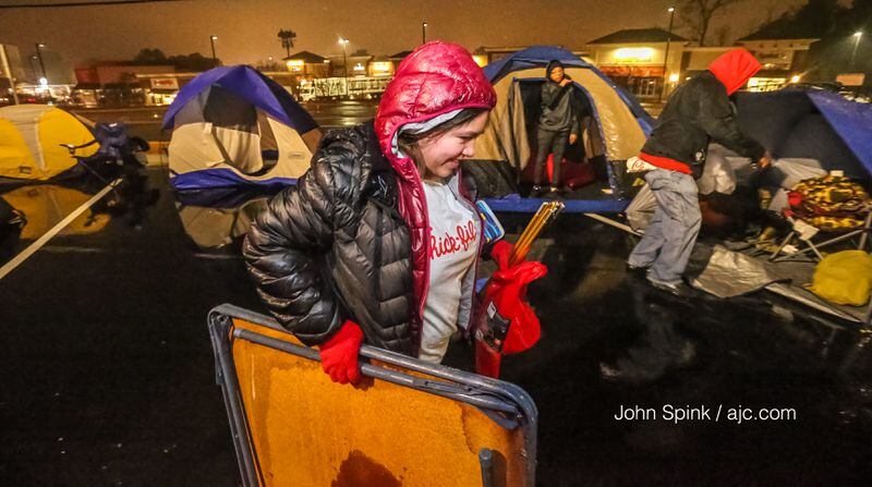 The rain did not stop Christina Sanchez from camping outside the new Chick-fil-A at North Druid Hills and Briarcliff roads. Her efforts were rewarded. She secured the first spot in line and received free meals for a year.  JOHN SPINK / JSPINK@AJC.COM