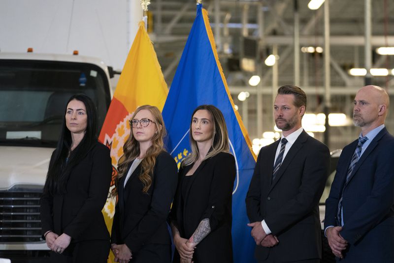 Investigators stand during a press conference regarding Project 24K a joint investigation into the theft of gold from Pearson International Airport, in Brampton, Ontario, on Wednesday, April 17, 2024. (Arlyn McAdorey/The Canadian Press via AP)
