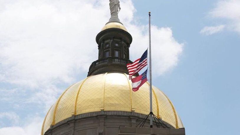 A flag flies at half-staff at the Gold Dome.