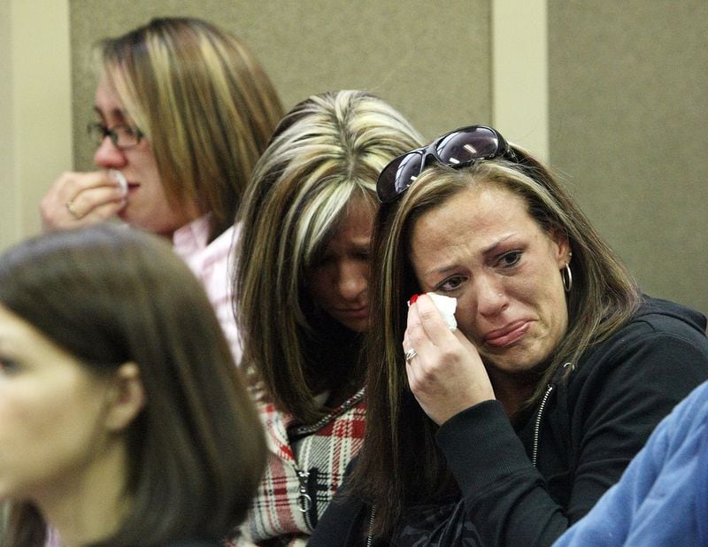 Relatives of Zachariah Werner cry as suspected shooter Jesse James Warren appears in a Cobb County court Marietta on February 26, 2010.