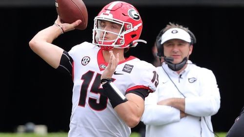 Georgia coach Kirby Smart looks on as quarterback Carson Beck completes a pass during the G-Day game at Sanford Stadium on Saturday, April 17, 2021, in Athens.   “Curtis Compton / Curtis.Compton@ajc.com”