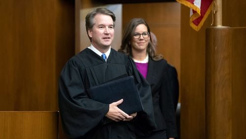 President Donald Trump's Supreme Court nominee, Judge Brett Kavanaugh, officiated in Washington Tuesday at the swearing-in of Judge Britt Grant, right, to take a seat on the U.S. Court of Appeals for the Eleventh Circuit