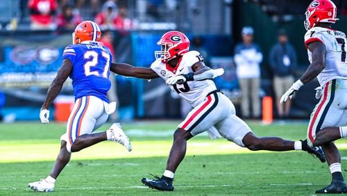 Georgia outside linebacker Adam Anderson (19) reaches for Florida running back Dameon Pierce during the Bulldogs' game the Gators at  TIAA Bank Field in Jacksonville, Fla., on Saturday, Oct. 30, 2021. (Photo by Rob Davis/UGA Athletics)