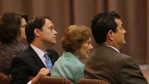 Rosalynn Carter, wife of Jimmy Carter, and his grandson Jason Carter listen during a news conference as the former president discusses his cancer treatment.