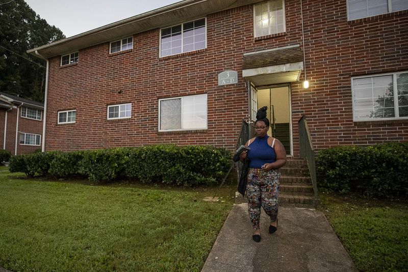 Tranisha Wilcox leaves her apartment at Pavilion Place in Atlanta to drive her eldest son Giovanni to school last fall. The basement of her building flooded when it rained, and water that smelled of human waste backed up into her bathtub. (Alyssa Pointer / AJC)