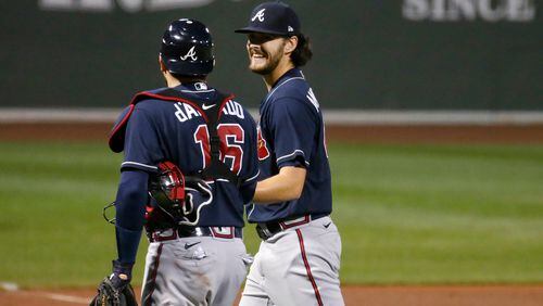 Braves starting pitcher Ian Anderson smiles as he talks to catcher Travis d'Arnaud at the end of the fourth inning of a game against the Boston Red Sox on Sept. 1 in Boston. (AP Photo/Mary Schwalm)
