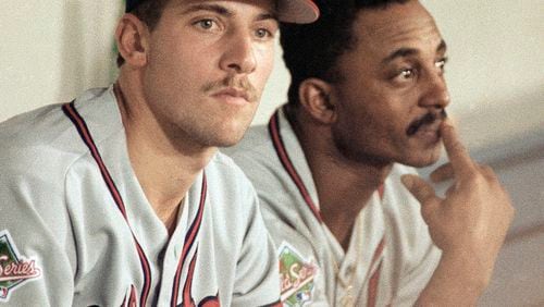 Atlanta Braves pitcher John Smoltz, left, the Game 7 starting pitcher against the Minnesota Twins, sits in the dugout with teammate Lonnie Smith after the Twins won game 6 with Kirby Puckett's homer the 11th inning, Saturday, Oct. 26, 1991, in Minneapolis, Minn.