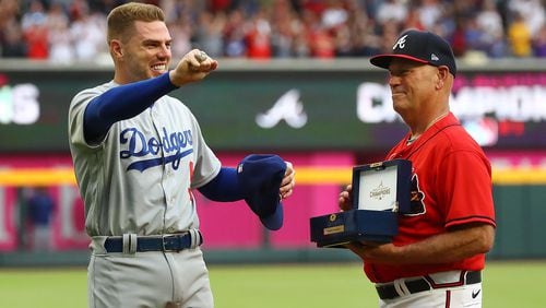 Atlanta: Braves manager Brian Snitker, right, presents former Atlanta Braves first baseman Freddie Freeman his World Series Championship ring, who shows it off to the fans during his ring presentation ceremony as he returns to Atlanta with the Los Angles Dodgers at Truist Park on Friday, June 24, 2022, in Atlanta. The series marks Freeman's first games in Atlanta since the longtime Braves star signed with the Dodgers as a free agent in March. (Curtis Compton/ccompton@ajc.com)