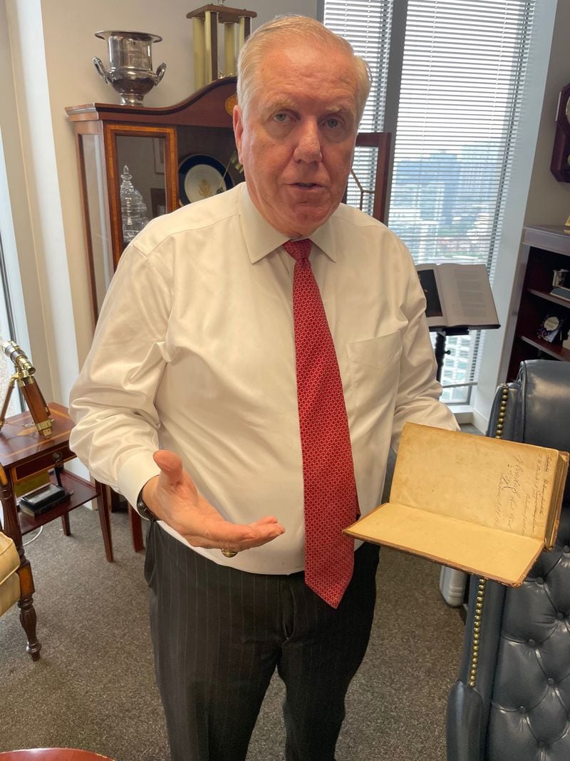 Randy Evans, a Georgia lawyer who was ambassador to Luxembourg, shows a Hebrew bible he received for helping solve a long-running dispute concerning Holocaust survivors. Photo by Bill Torpy