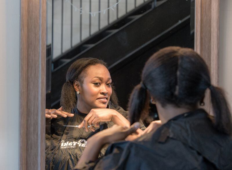 Sade Berry takes suggestions and trims a minimum amount off the ends of her even ponytails on Wednesday, April 15, 2020 at the closed StarTaki Salon in Sandy Springs. Photo: Jenni Girtman/Atlanta Journal-Constitution